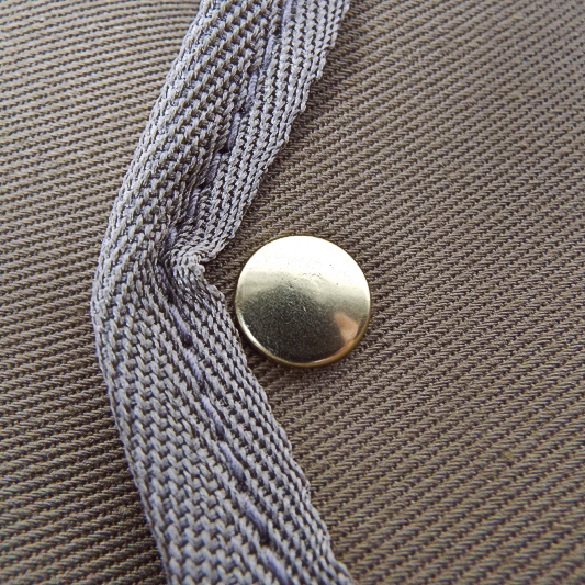 Original Peter brass popper fastener detail showing high quality hand made in England manufacturing techniques.
